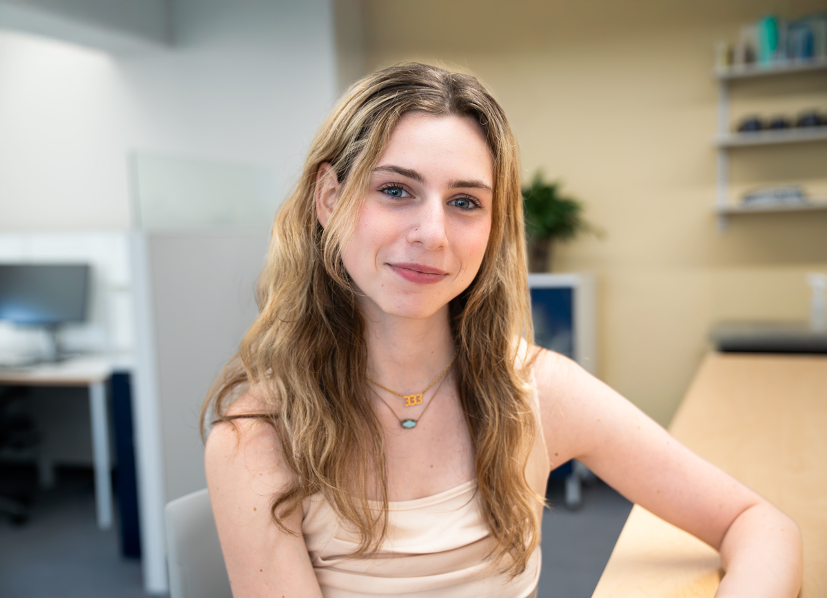 Here is what the image shows: An unraveled ceiling light with four lit bulbs shines in a white ceiling and walls room and ...