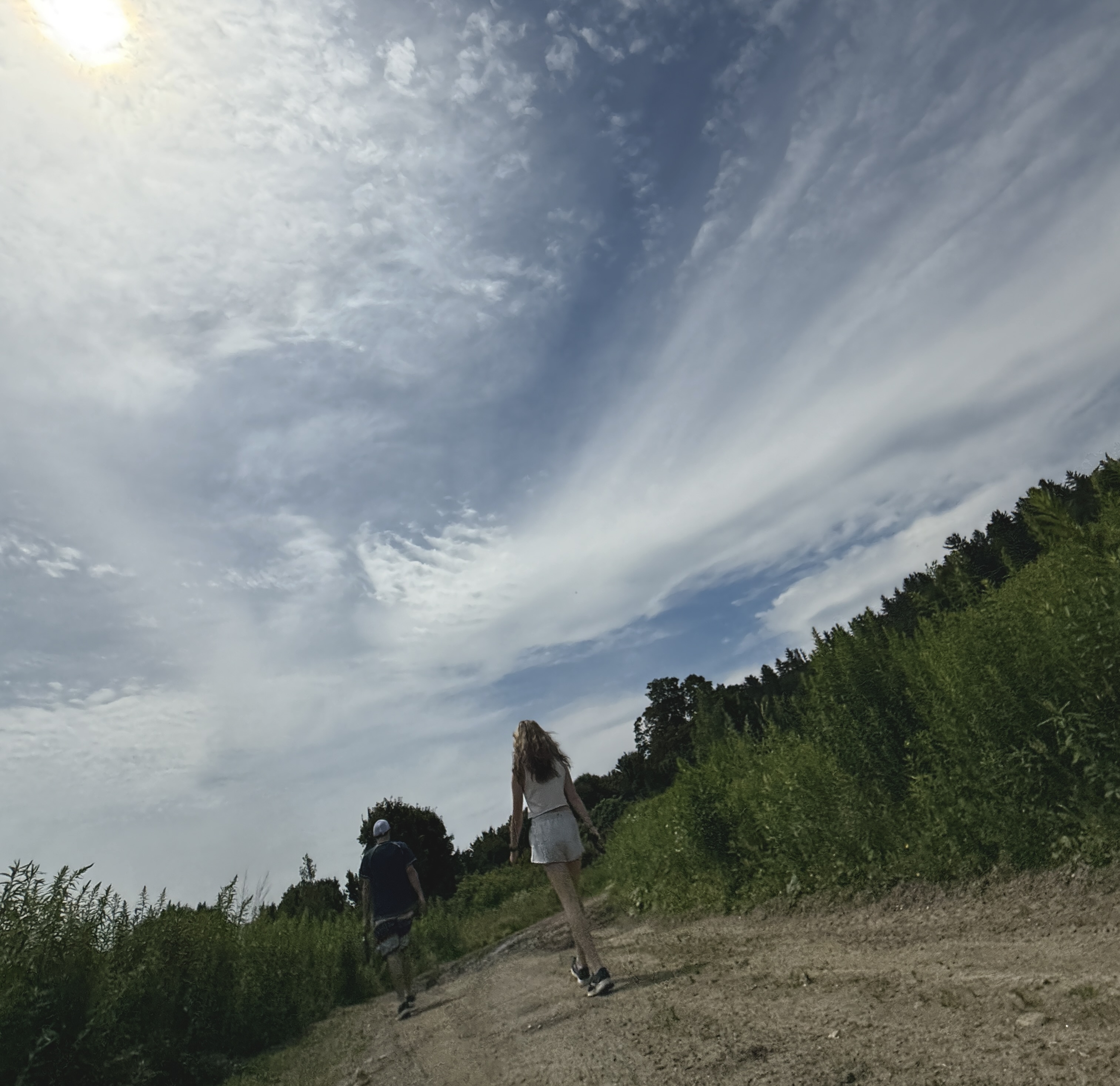 Here is what the image shows: An unraveled ceiling light with four lit bulbs shines in a white ceiling and walls room and ...